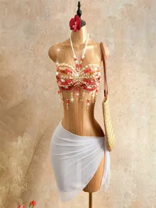 Detailed view of handmade bohemian beaded halter top with fringe tassels for beach wear