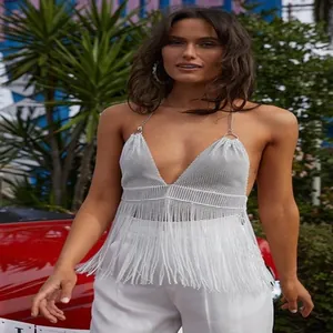 Detail view of a silver metallic mesh halter top featuring long dangling fringes.