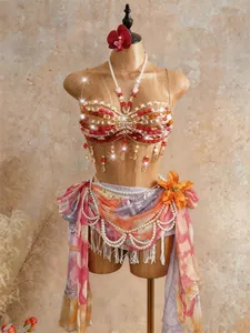Detailed view of handmade bohemian beaded halter top and fringed beach wrap skirt
