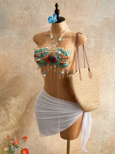 Detailed view of a bohemian handmade beaded halter top featuring colorful fringe tassels