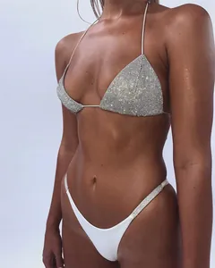Detailed view of sparkling silver rhinestone triangle bikini top and high-cut white bottoms