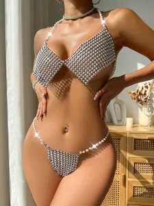Close-up detail of sexy metallic silver bead and white pearl halter bikini set for women