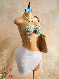 Detailed view of colorful handmade beads and tassels on a bohemian halter beach top.