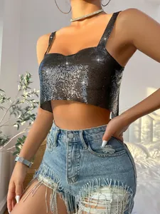 Close-up view of a black sequin metallic camisole top paired with fringe denim shorts