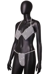Detailed view of a handmade white pearl halter bikini set displayed on a black mannequin.