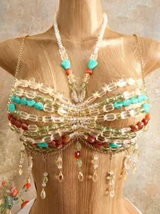 Close-up of bohemian handmade beaded halter top with colorful stones and tassels