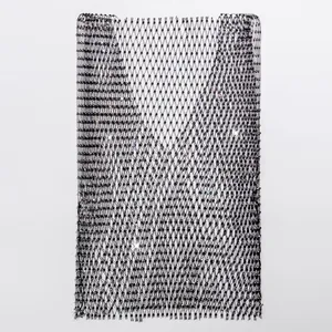 Detailed view of the sparkling rhinestone embellishments on black fishnet fabric