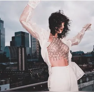 Gemstone patchwork chainmail halter top styled with a sheer white shirt on rooftop