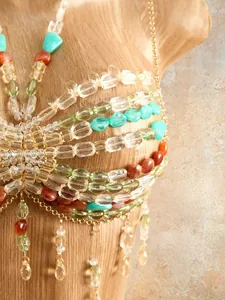 Macro detail view of bohemian handmade beaded halter top for beach vacation wear