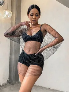 Close-up detail of black long sleeve fishnet mesh dress with sparkling rhinestone accents