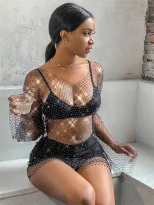 Detailed view of elegant black long sleeve fishnet dress with sparkling rhinestones