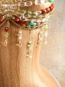 Macro detail of exquisite bohemian handmade beaded halter top with colorful tassels.