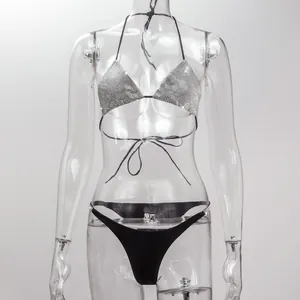 Close-up detail of sparkling silver rhinestone triangle bikini top and black bikini bottom