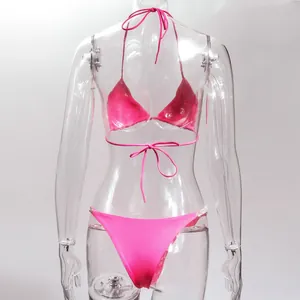Rear view of hot pink two-piece bikini with rhinestone detailing on transparent mannequin