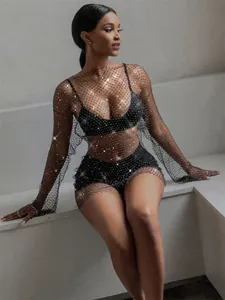 Detail shot of sparkly black mesh long sleeve dress with rhinestone embellishments
