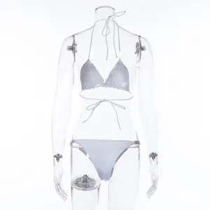 Front detail view of white two-piece triangle bikini set on transparent mannequin