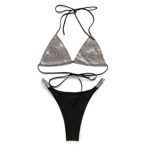 Detailed view of a sparkling silver sequin bikini top with matching black bottoms