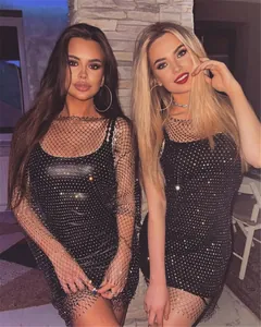 Detail shot of a glamorous sparkling black mesh dress worn by models in a party setting.