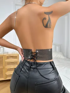 Detailed back view of a black backless crop top with sparkling rhinestones and lacing.