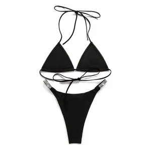 Detailed view of sexy black two-piece bikini set with elegant rhinestone trim and side straps.