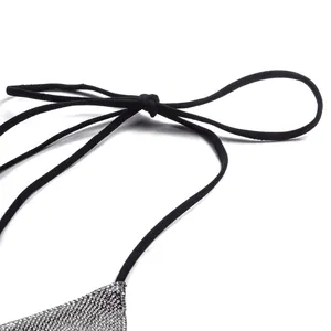 Close-up of black tie strap and sparkling silver rhinestone texture on sexy bikini