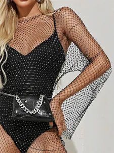 Detailed view of black mesh fabric with sparkling rhinestones on long sleeve dress