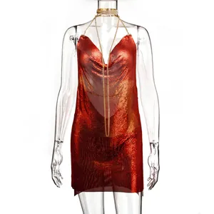 Close-up detail of a sexy red metallic chainmail mini dress with a deep V-neck design