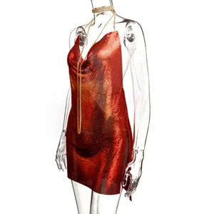 Detail of red gradient metallic mesh dress with cowl neck and chain straps on mannequin
