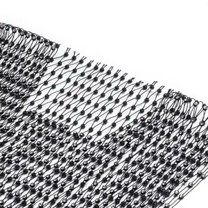 Close-up detail of black mesh fabric with sparkling rhinestones for elegant dress