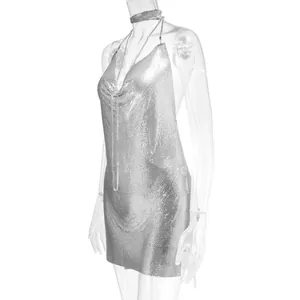 Detailed macro view of a shiny silver metallic mesh backless halter mini dress.