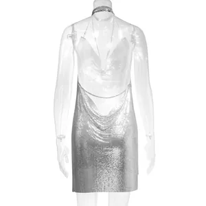 Back view of sexy silver metal mesh mini dress featuring backless chain halter design