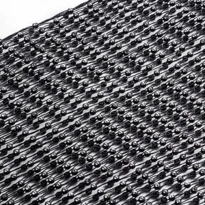 Macro detail showing the texture of black mesh fabric adorned with shiny rhinestones.