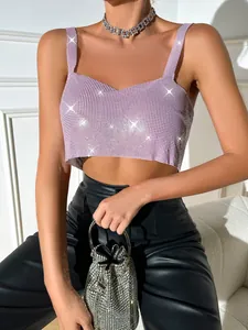Detail shot of a pink sequined crop top camisole paired with black leather pants