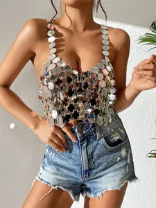 Close-up of shiny silver acrylic disc sequins on a sexy backless halter top for parties