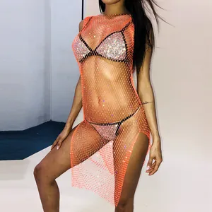 Detailed close-up of orange mesh rhinestone dress with shimmering fishnet pattern