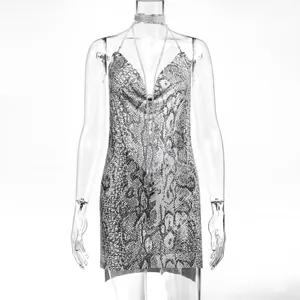 Close-up of sexy deep V-neck metallic snakeskin print chain halter mini dress
