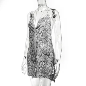 Detail view of the sexy snakeskin metallic chainmail mini dress with a deep V-neckline.