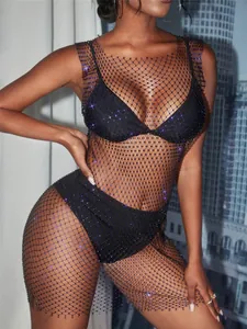 Detailed view of elegant black mesh dress with shimmering rhinestones and cut-out design