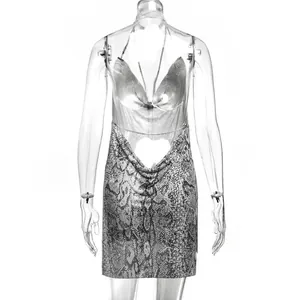 Detailed view of the backless metallic chainmail mini dress with snakeskin animal print