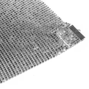 Detail view of high quality silver metallic mesh fabric for a sexy nightclub party dress