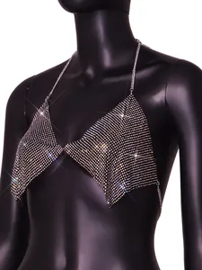 Detailed macro view of sparkly rhinestone mesh halter crop top with silver chain straps