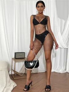 Detailed view of elegant black rhinestone mesh mini dress over bikini set look