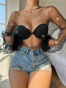 Detail view of black long sleeve rhinestone fishnet top with feather cuffs and sparkle