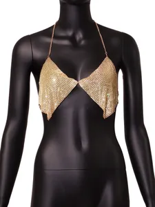 Close-up view of golden rhinestone halter top with glittering mesh and chain details