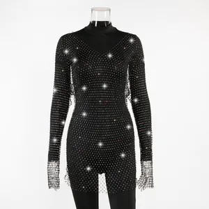 Detail of elegant black long-sleeved mesh dress with sparkling rhinestones decor