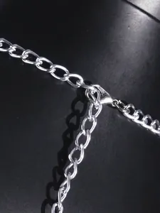 Close-up detail of silver acrylic mirror chain links featuring a secure lobster clasp