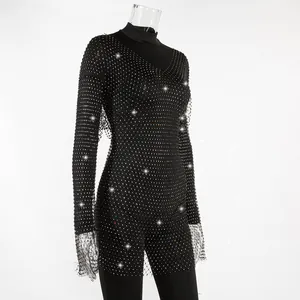 Detail of black long-sleeved mesh dress with sparkling rhinestone embellishments