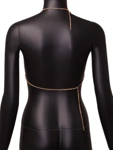 Detailed back view of minimalist gold body chain jewelry on a black mannequin torso