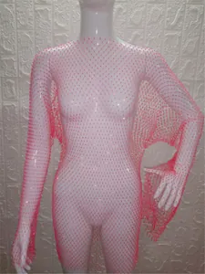 Close-up view of a pink long-sleeved fishnet mesh dress with sparkling rhinestone details