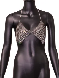 Close-up detail of sparkling rhinestone halter top with chain straps on a black mannequin